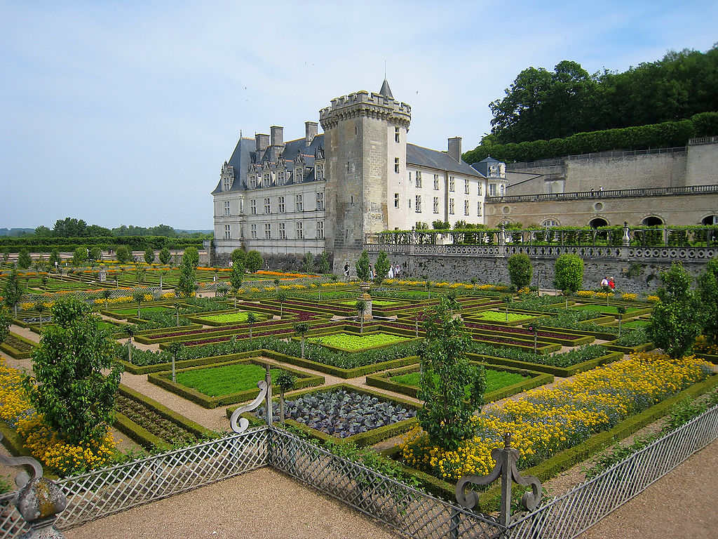 Loire Valley chateau de Villandry kitchen garden looing at chateau and large tower in distance and in front very well organised beds of vegetables enclosed by small box hedges