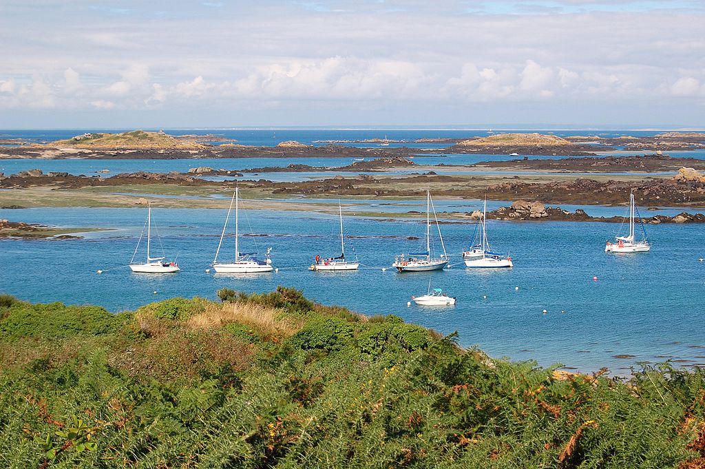 Chauseyisland Normandy France from headland showing boats anchored in front with more headlands and sea harbours behind