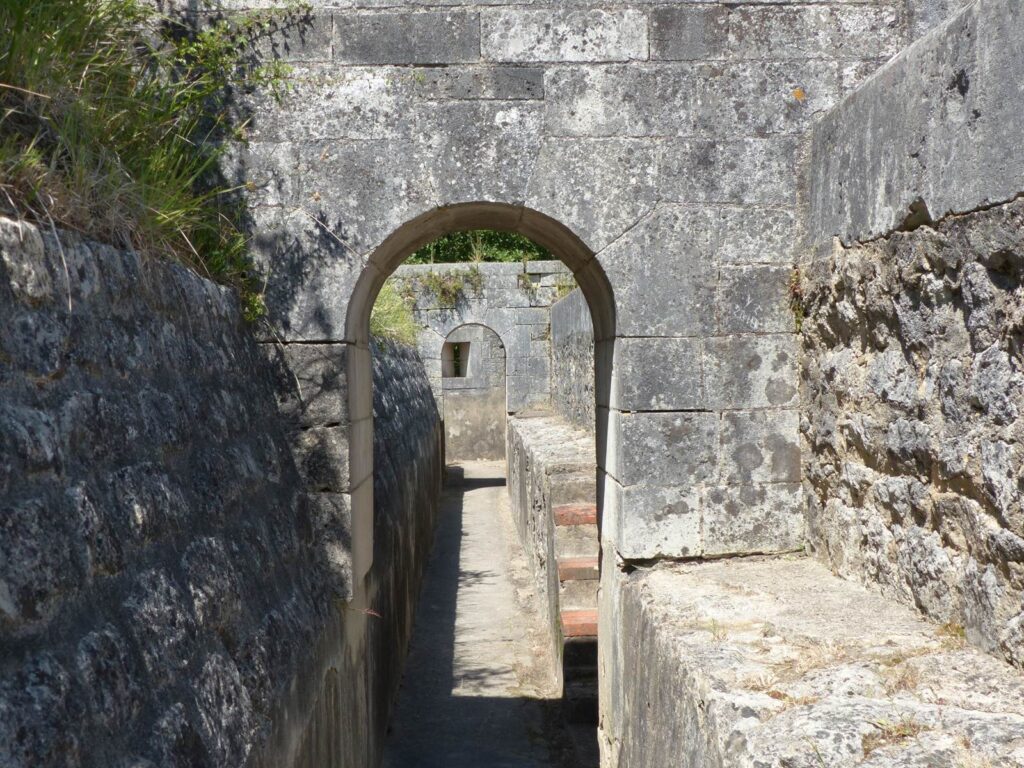 Fort Liedot on Ile d'Aix looking along path between stone arches below ground