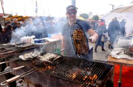 Herring Festival Dieppe with man cooking herrings on grill over fire
