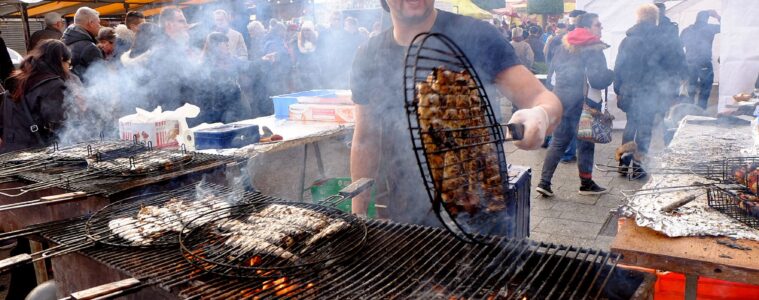 Herring Festival Dieppe with man cooking herrings on grill over fire