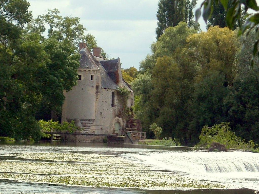 Moulin de Merve Loir valley with stone mill with tower at background and river in front