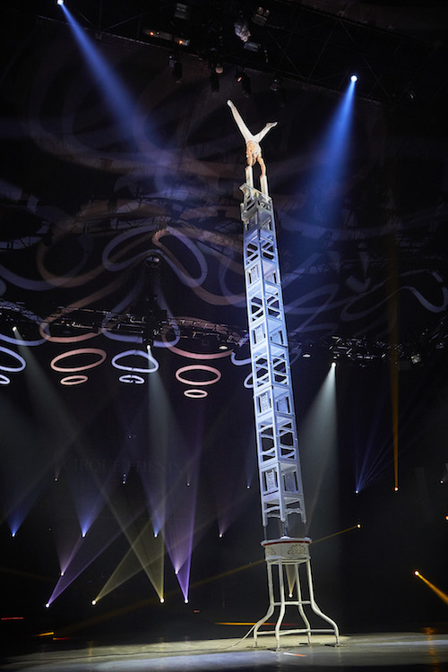 World Circus Festival showing acrobat at top of huge steel climb doing a handstand