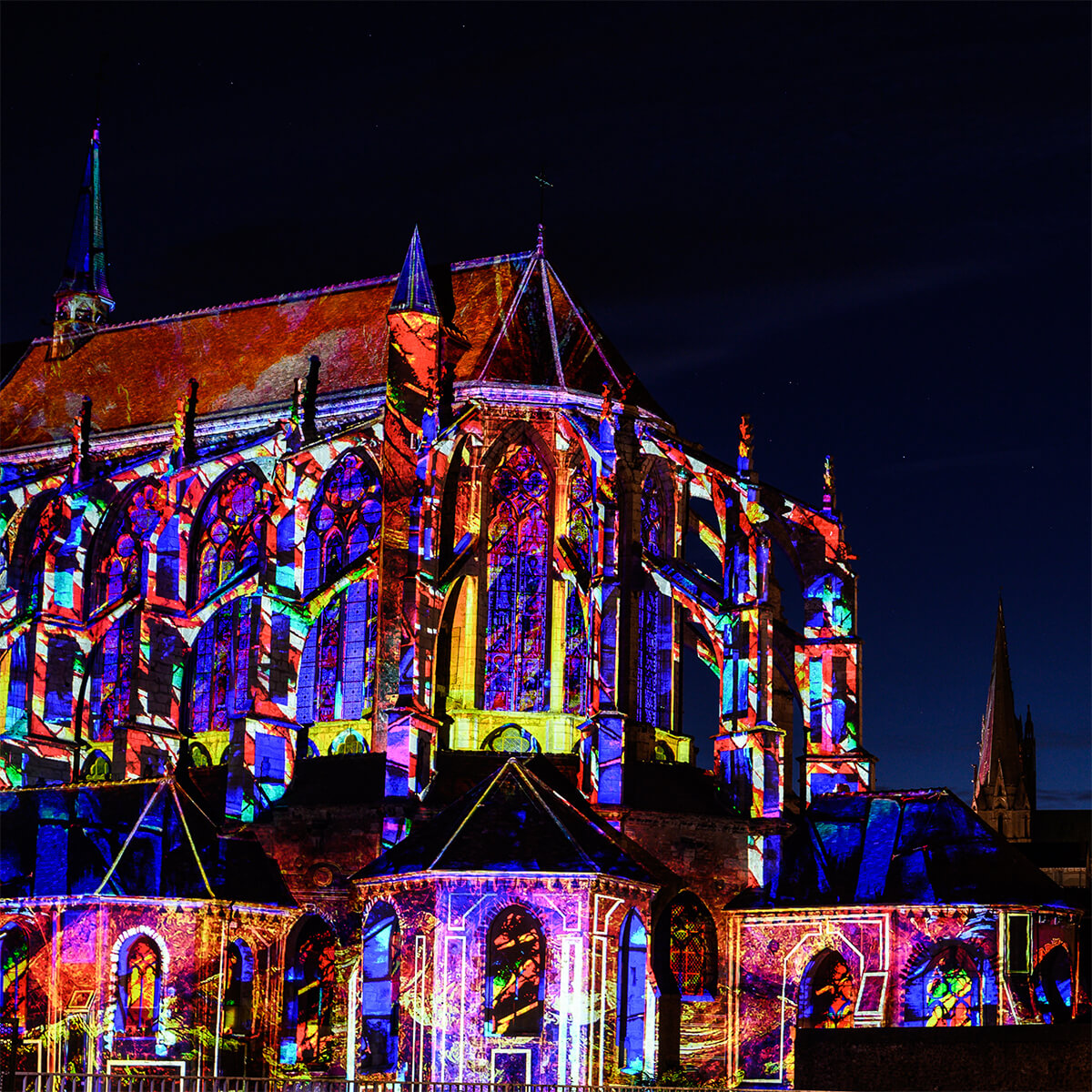 Chartres lit up with multi coloured lights on the cathedral