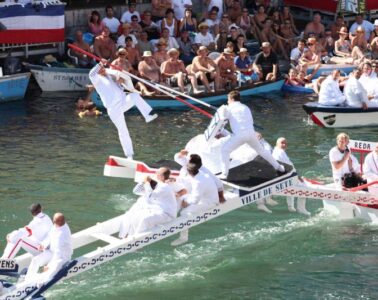 Festival Saint-Louis in Sete showing men in white on boat with one man pushing another off with pole into the water