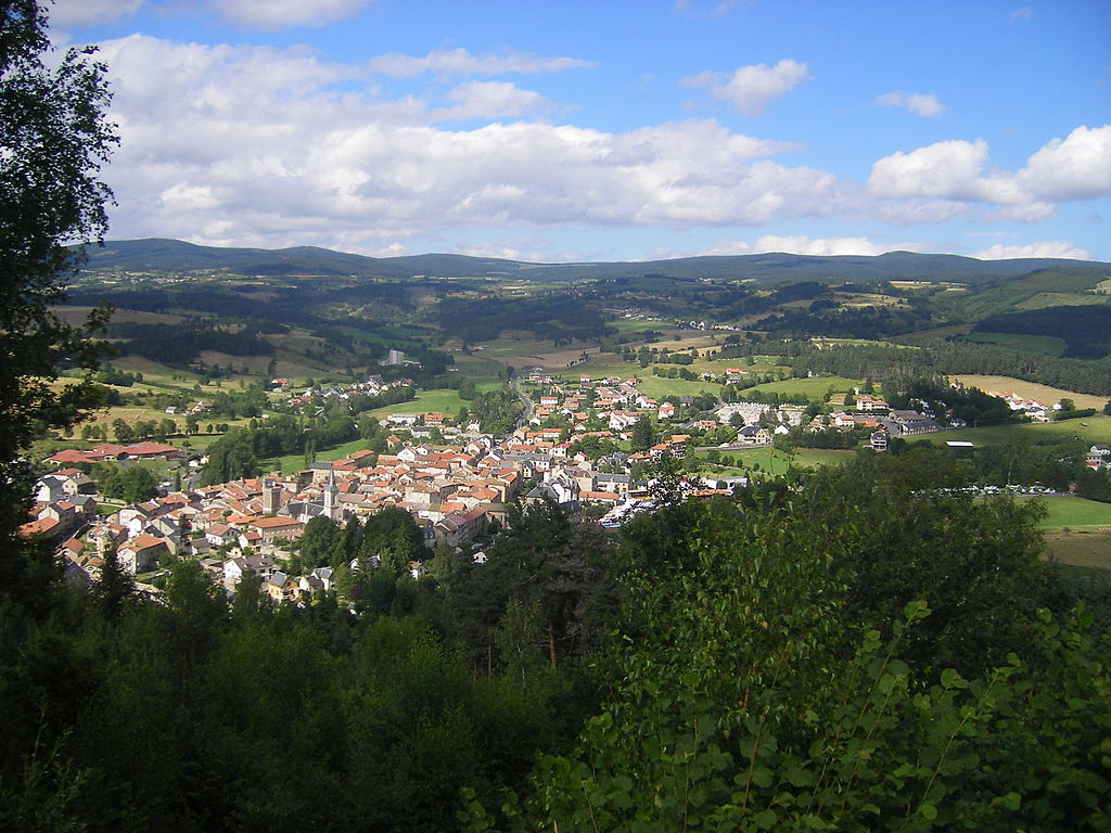 Le Malzieur-Vielle view from far away from hilltop of the village on sloping hill with Margueride hills in background