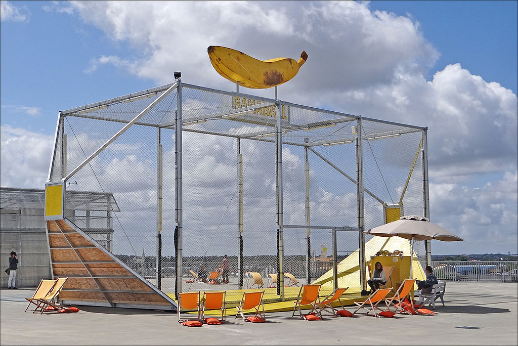 Voyage a Nantes installation on the roof of the architectural school showing cage with deck chairs and giant banana on roof
