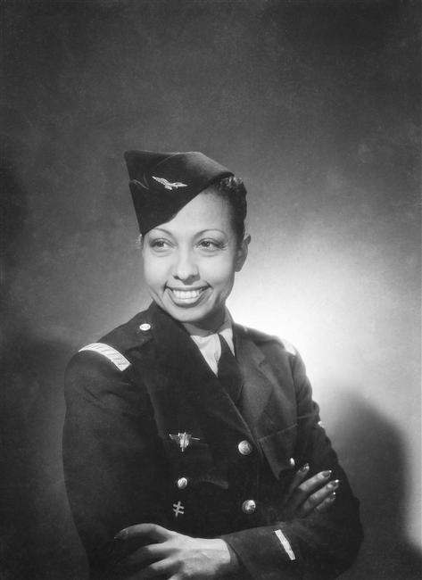 Black and white phot of Josephine Baker in uniform lit from behind, taken by Studio Harcourt