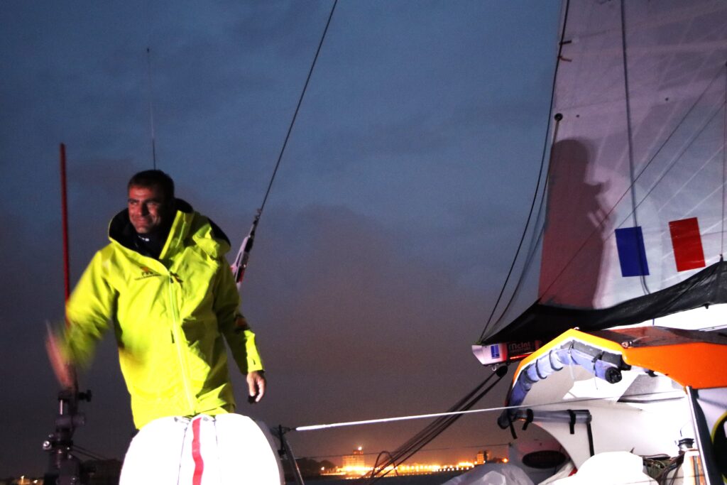 Night shot of Damien Gillou on boat in yellow jacket on boat in GGR 2022