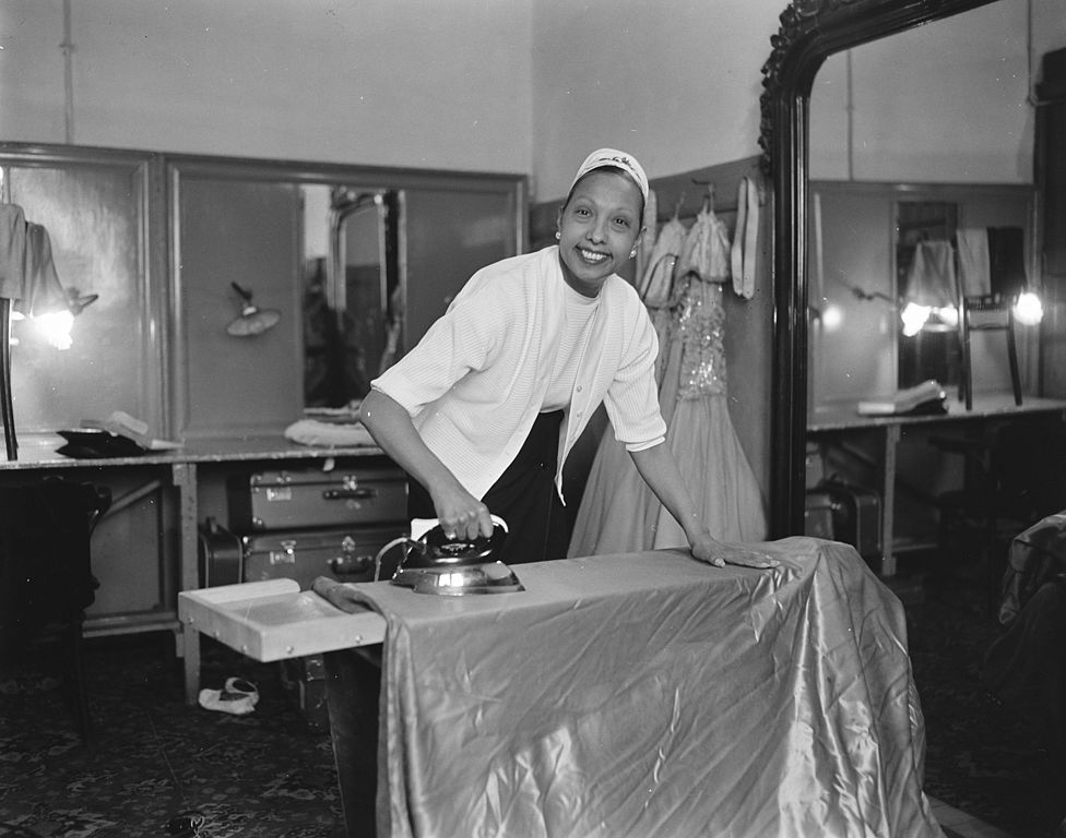 Black and white photo of Josephine Baker ironing in her dressing room