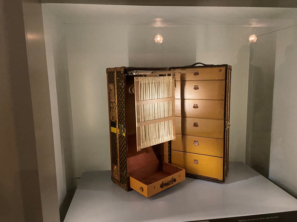 Escal'Atlantic exhibit of open large Louis Vuitton cabin trunk with hangers and shelves and drawers