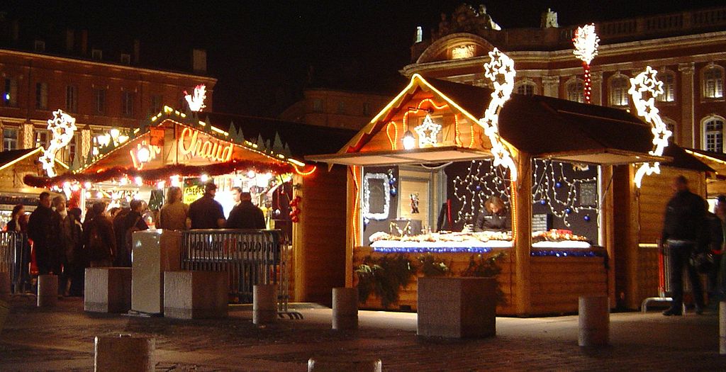 Toulouse Christmas Market with two little wooden chalets lit up and with silver decorations