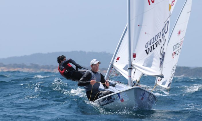 World sailing event france april 2023 with twopeople in boat one leaving out, other navigating in blue seas