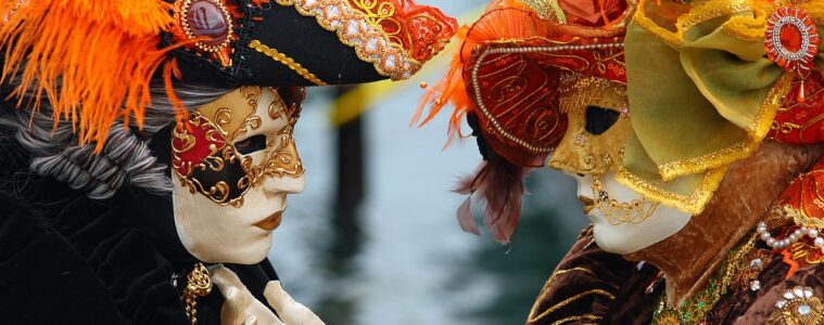 Annecy's Venetian carnival withtwo figures facing each other in elaborate costumes and particularly hats and masks. Woman touching man on chin