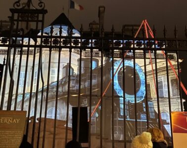 Les Habits de Lumiere epernay 2022 with huge old train illuminated onto chateau wall behind fencing
