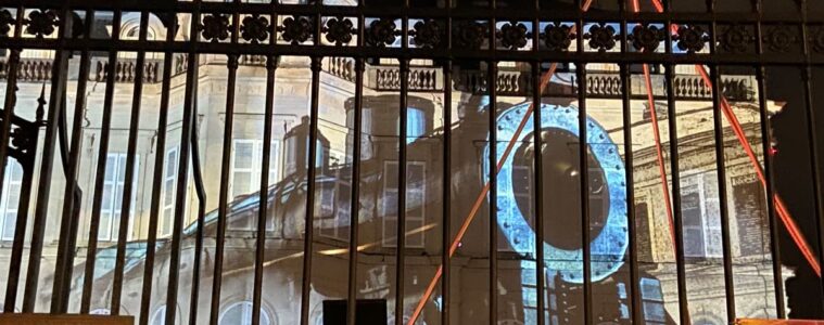 Les Habits de Lumiere epernay 2022 with huge old train illuminated onto chateau wall behind fencing