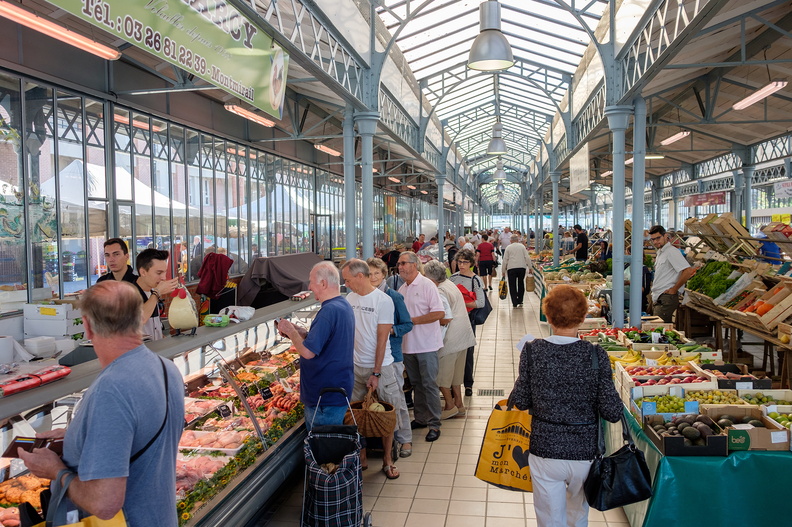 Epernay Saint Thibault covered market showing long aisle with stalls on each side and people selling and buying under huge glass and cast iron roof