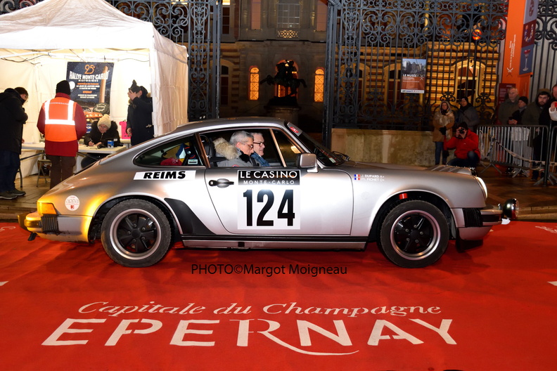 Epernay monte carlo rally with silver porsche in front of hotel de ville registering the race on red carpet with Epernay written on it