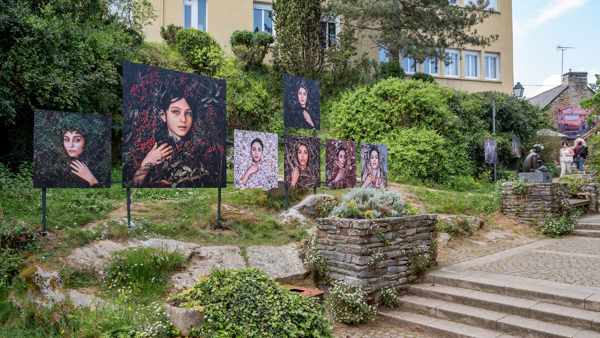 La Gacilly Photo Festival with huge coloured photos of faces on outdoor panels in garden