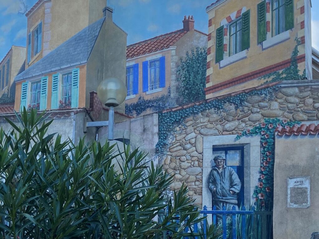 Mural in Les Sables d'Olonne showing painted upp part of house with man standing in doorway of a buvette