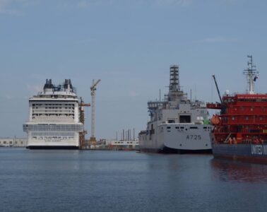 Chantiers de l'Atlantique shipyards in Saint-nazaire with two huge boats being constructed in the water in distance