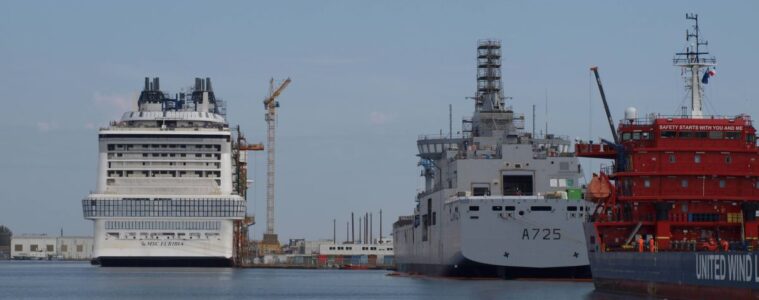 Chantiers de l'Atlantique shipyards in Saint-nazaire with two huge boats being constructed in the water in distance