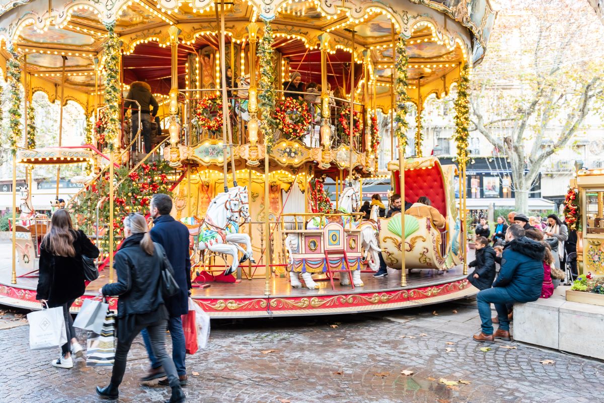Avignon Christmas Market day with huge old carousel going round and people looking and walking past
