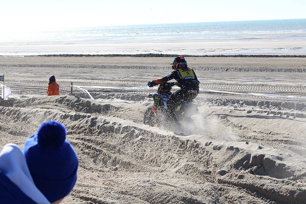Le Touquet Paris Plage France events 2024 with motorbikes on sandy beach against backdrop of sea and sky