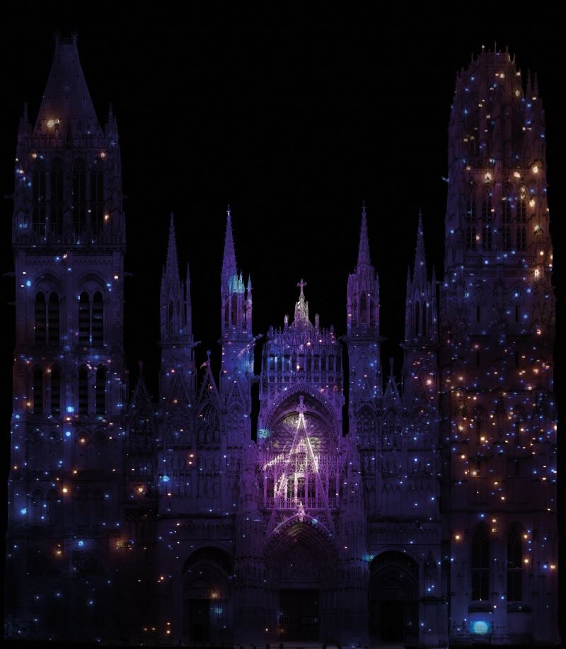 Rouen Cathedral lit up with dark facade and many little lights