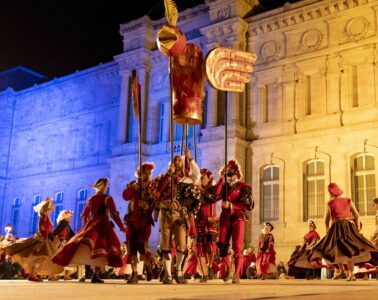 Le Puy en Velay Bird Festival with costumed actors at night in square