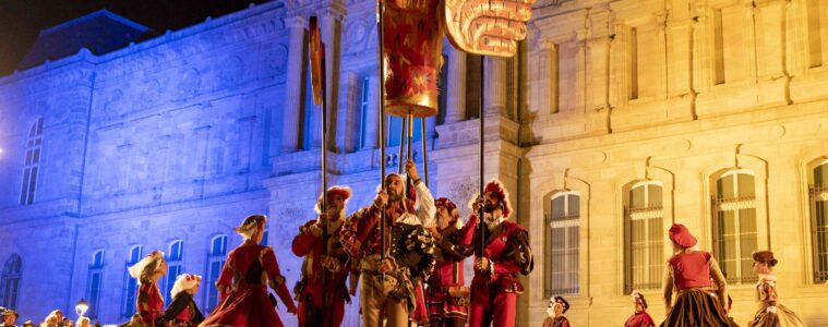 Le Puy en Velay Bird Festival with costumed actors at night in square