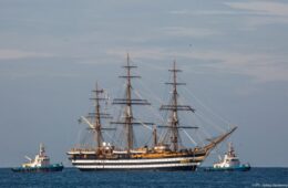 Amerigo Tall Ship with huge 3-masted boat with sails furled on sea
