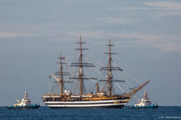 Amerigo Tall Ship with huge 3-masted boat with sails furled on sea