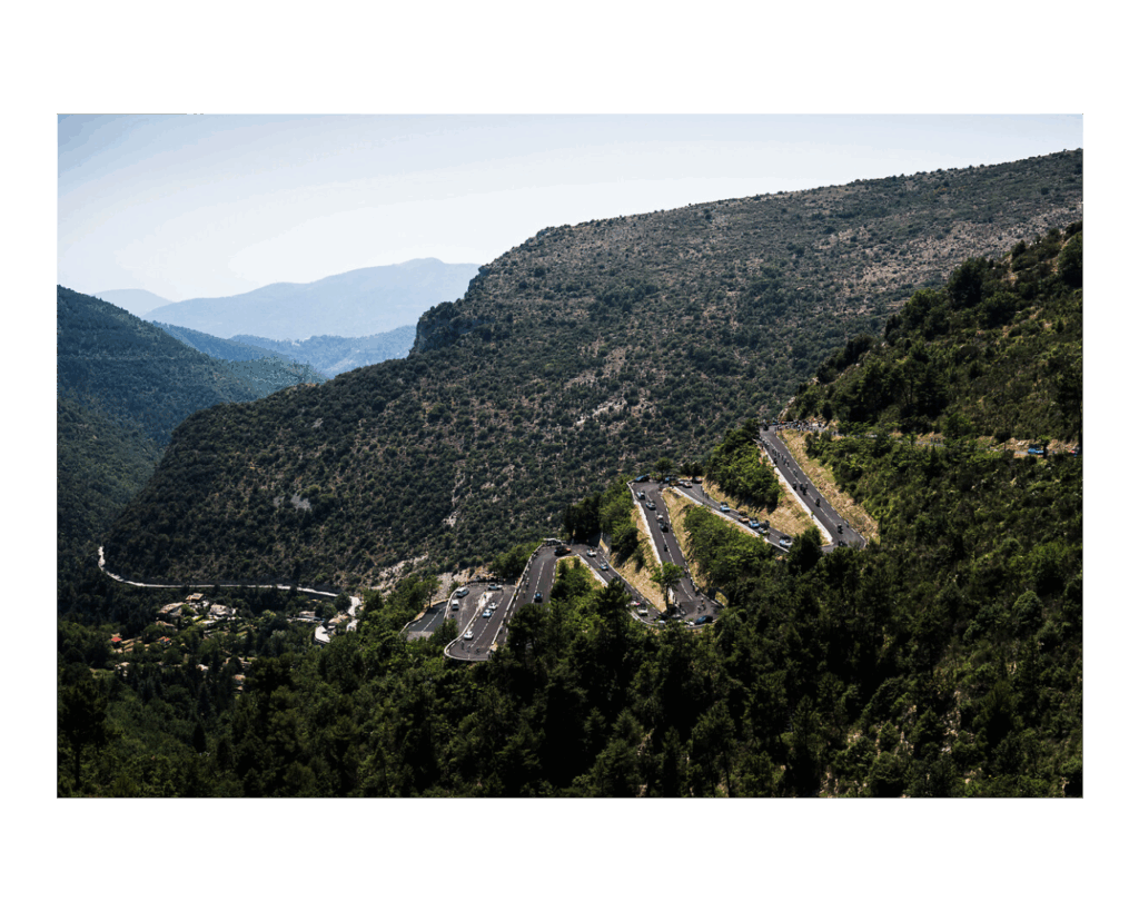 tur de France 2024 view of huge hairpin bend clim with mountains behind near Nice