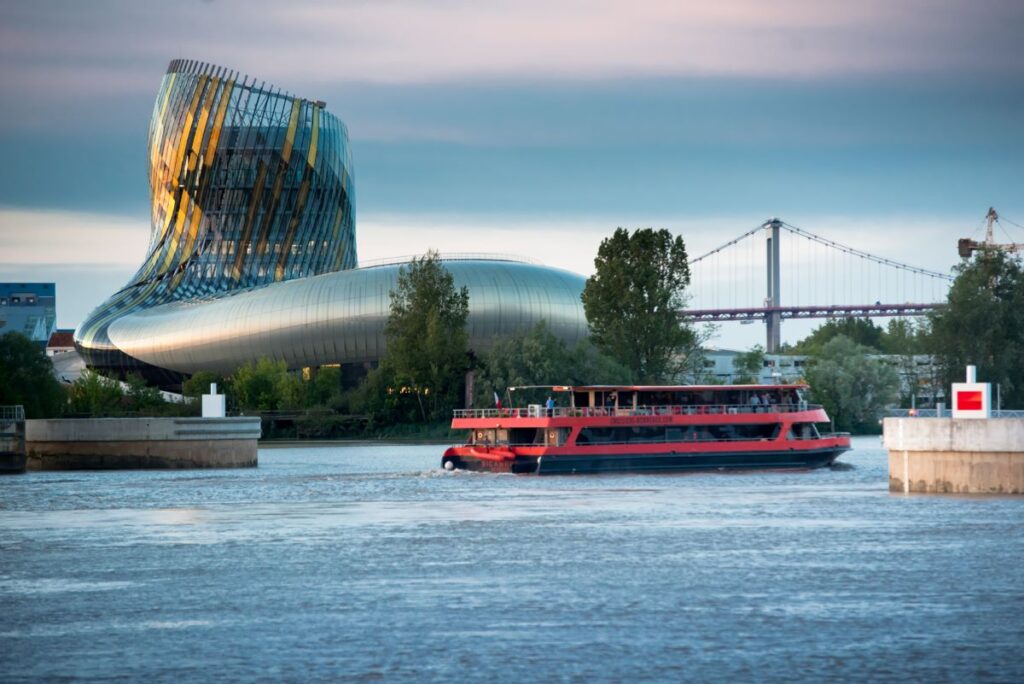 cite du vin fromthewater with boatin front