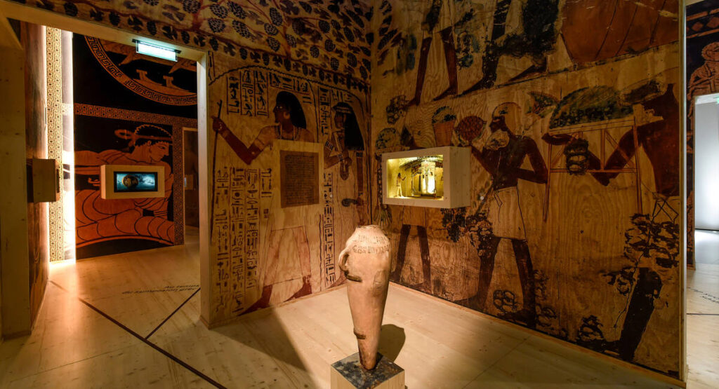 Cité du Vin gallery with egyptian section and amphora in middle and ancient Egyptian images on walls