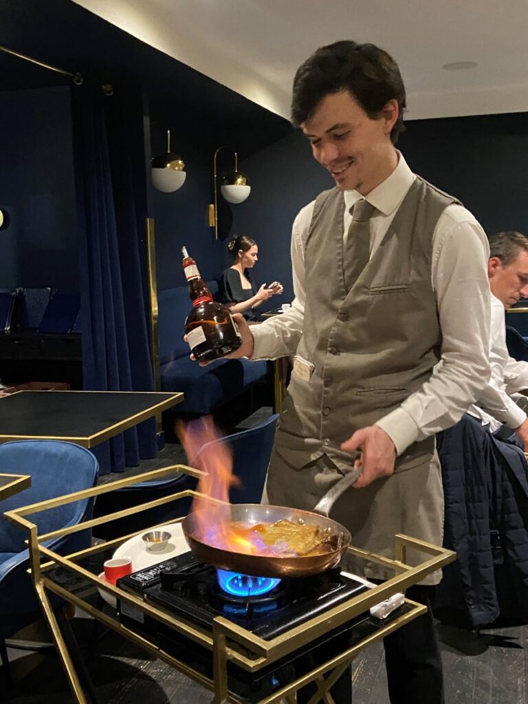 Bordeaux Le 1925 Brasserie with waiter flaming crepes suzette beside table