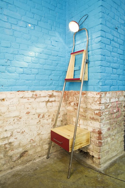 Roubaix Braderie with step ladder against old brick wall painted blue converted with box at top and bottom steps added