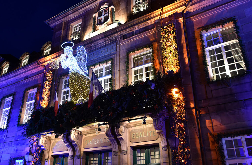 Montbeliard Christmas with old house lit up and angel flying in front