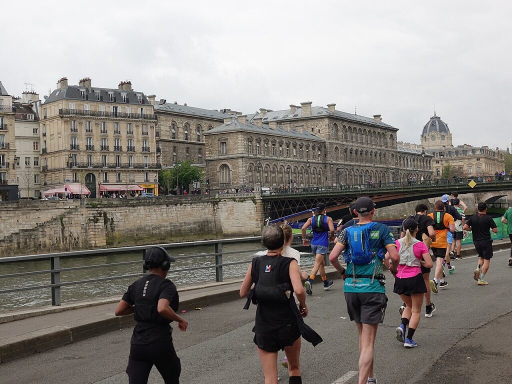 2025 Paris Marathon with runners running away fromphotographer on Seine banks