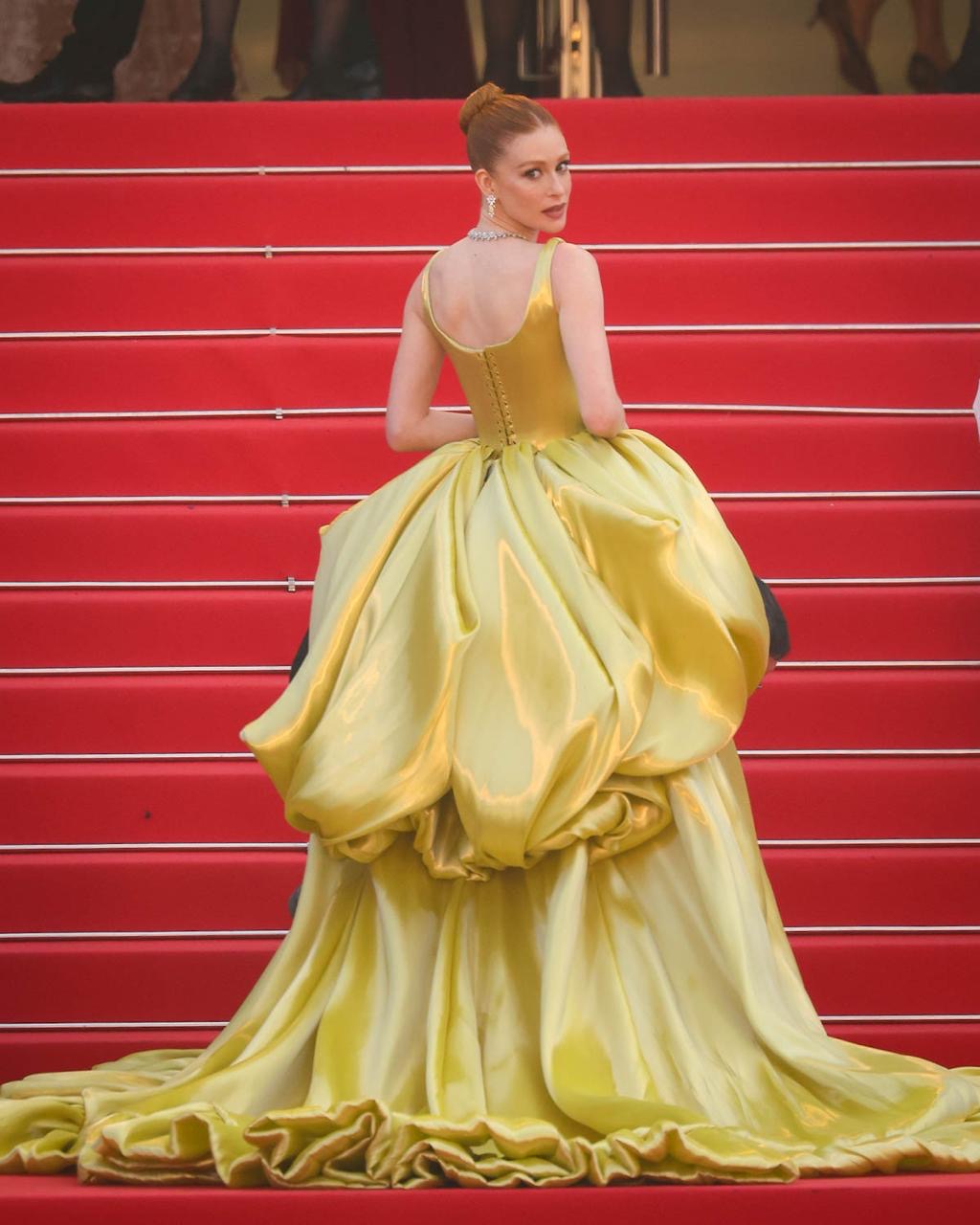 Marina Ruy Barbosa at the 2024 cannes film festival in gorgeous yellow dress looking over her shoulder on red carpet