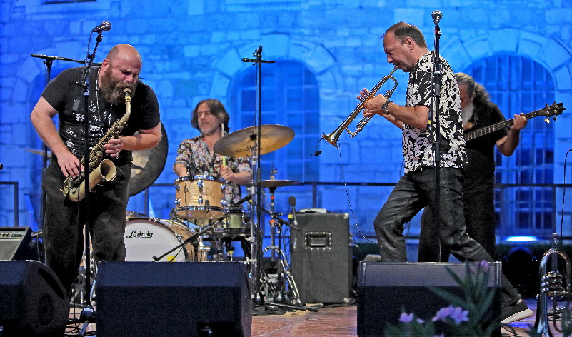 Souillac Jazz with three musians on stage playing instruments