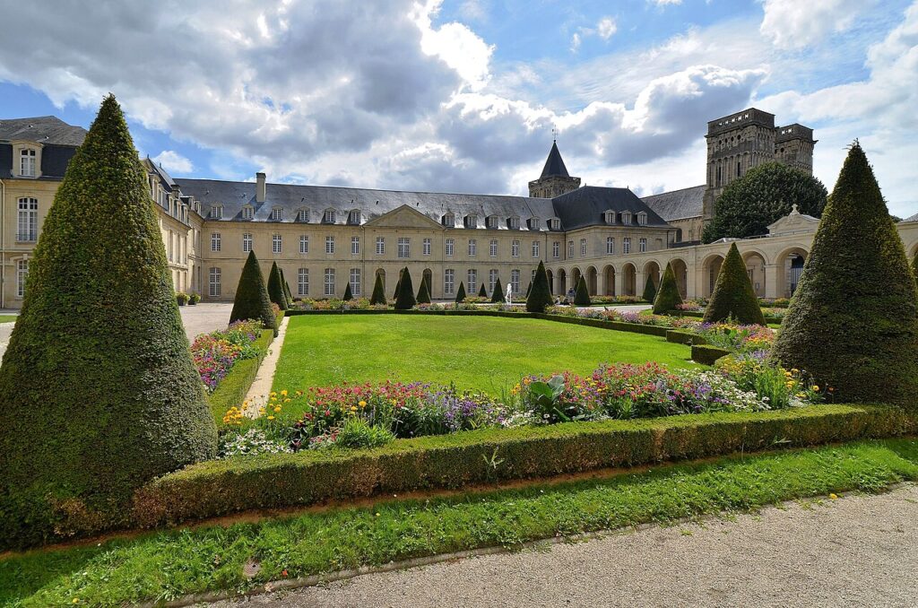 Abbaye aux dames Caen with buildings on three sides around green lawns