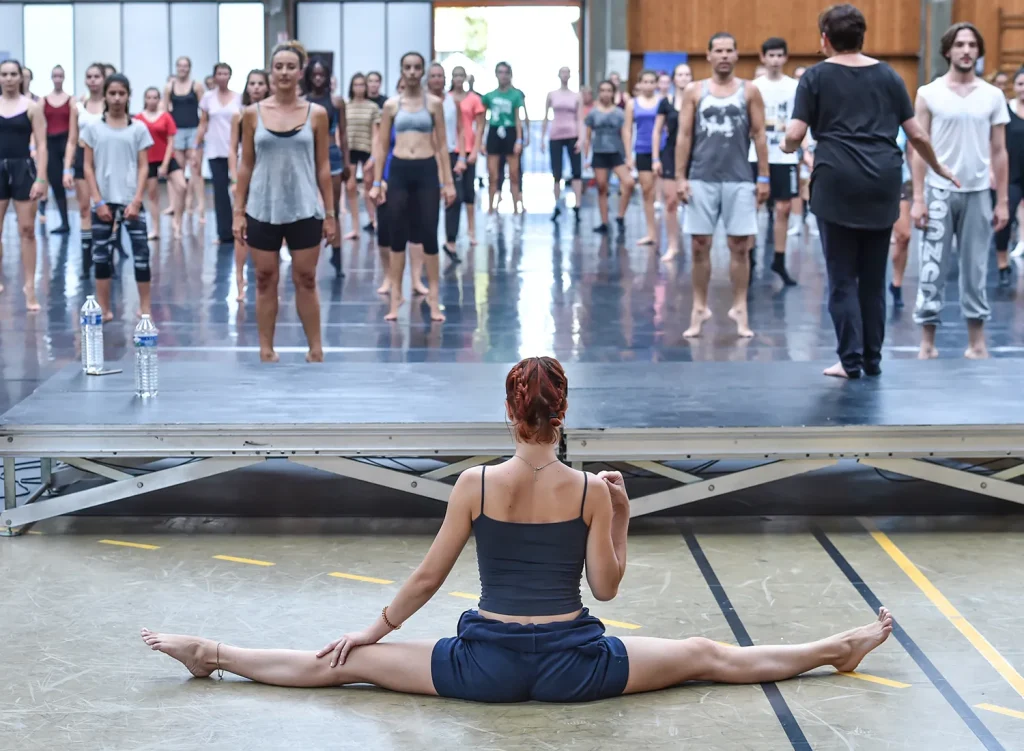 Darc Festival with girl with legs stretched at right angles on floor and people watching