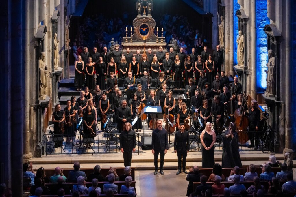 Berlioz Festival with singers and musicians on tiered seats on stage and audience in front