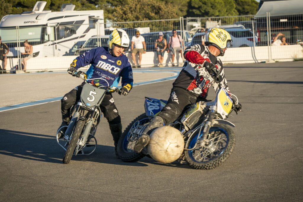 Bol d'Or with 2 motorbikes playing football with football beside one of them