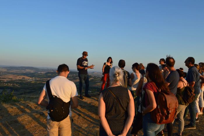European night Gergovie man leading group of walkers at dusk
