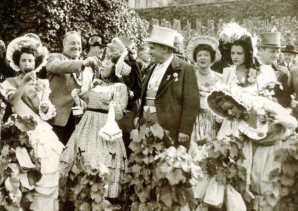 Black and white photo of fete des vendanges montmartre 1939 with top hats and womens costumes