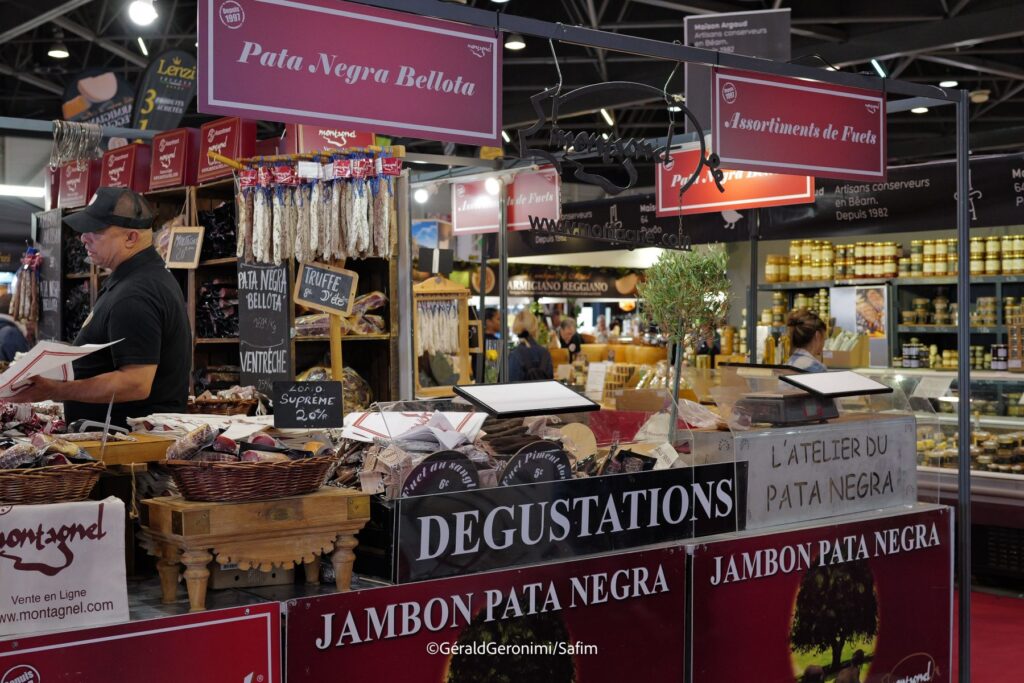 Marseille food fair with large stall of hams