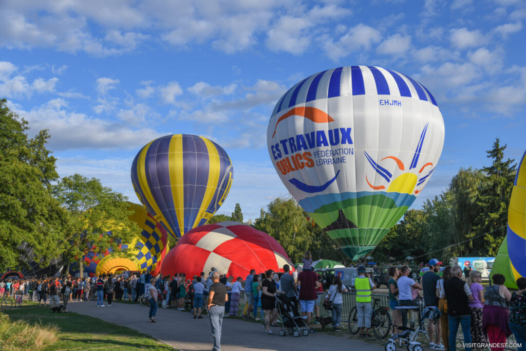 Montgolfiades de Metz with huge hot air balloons tethered near ground and spectaors